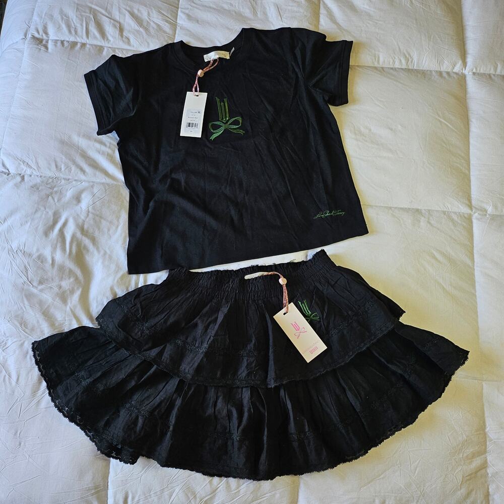 LoveShackFancy x Wicked collaboration Lia Tee featuring a green embroidered bow